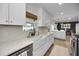 Farmhouse sink and white cabinetry create a charming and stylish kitchen at 1557 77Th N Ave, St Petersburg, FL 33702