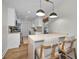Eat-in kitchen with white cabinets, modern pendant lighting, and a quartz countertop breakfast bar at 1557 77Th N Ave, St Petersburg, FL 33702