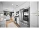 Modern kitchen featuring stainless steel appliances, white cabinets, and an open layout at 1557 77Th N Ave, St Petersburg, FL 33702
