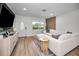 Stylized living room boasts a comfortable sectional sofa, wood accent wall, and bright, natural light at 1557 77Th N Ave, St Petersburg, FL 33702