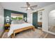 Inviting primary bedroom featuring a modern ceiling fan, ensuite access, and natural light at 1557 77Th N Ave, St Petersburg, FL 33702