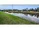 Waterfront view of a canal with lush green banks and surrounding neighborhood at 1557 77Th N Ave, St Petersburg, FL 33702