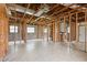 Unfinished basement displaying exposed framework, tiled flooring, and ample space for customization, highlighted by natural light at 1560 Connecticut Ne Ave, St Petersburg, FL 33703