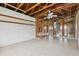 Spacious unfinished basement with exposed wooden beams, tiled floors, and potential for customization, showcasing ample space at 1560 Connecticut Ne Ave, St Petersburg, FL 33703
