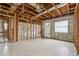 Large unfinished basement with open framework, showcasing potential for customization and featuring tile flooring and natural light at 1560 Connecticut Ne Ave, St Petersburg, FL 33703