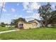 A single-Gathering home with mature landscaping, featuring a clean design and lush greenery in a tranquil residential area at 1560 Connecticut Ne Ave, St Petersburg, FL 33703