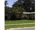 Single-Gathering home with a well-kept lawn, presenting an attractive exterior in a peaceful neighborhood setting with mature trees at 1560 Connecticut Ne Ave, St Petersburg, FL 33703