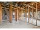 Interior view of a gutted room shows the studs, plumbing, and block walls at 1560 Connecticut Ne Ave, St Petersburg, FL 33703
