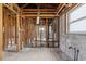 Interior view of a gutted room shows the studs, plumbing, and block walls at 1560 Connecticut Ne Ave, St Petersburg, FL 33703