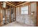 Interior view of a gutted room shows the studs, plumbing, and block walls at 1560 Connecticut Ne Ave, St Petersburg, FL 33703