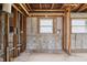 Interior view of a gutted room shows the studs, plumbing, and block walls at 1560 Connecticut Ne Ave, St Petersburg, FL 33703