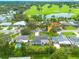 Aerial view of neighborhood, property, golf course and pond at 1723 Cypress Ave, Belleair, FL 33756