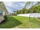 Fenced backyard featuring new sod, plants, and views of lush landscaping at 1723 Cypress Ave, Belleair, FL 33756