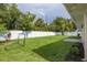 Large backyard featuring new sod, plants, and a white vinyl fence at 1723 Cypress Ave, Belleair, FL 33756