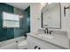 Bathroom featuring glass enclosed tub/shower, white vanity with quartz countertop and a modern mirror at 1723 Cypress Ave, Belleair, FL 33756