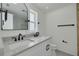 Modern bathroom features double sinks, black fixtures, and an arched mirror at 1723 Cypress Ave, Belleair, FL 33756