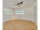 Clean bedroom featuring hardwood floors, natural light and new fixtures at 1723 Cypress Ave, Belleair, FL 33756