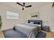 Nicely staged bedroom with light colored wood floors and a dark blue upholstered bed frame at 1723 Cypress Ave, Belleair, FL 33756