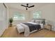 Charming bedroom with ceiling fan, stylish rug, and large windows at 1723 Cypress Ave, Belleair, FL 33756