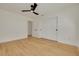 Bright bedroom features wood flooring, white walls, closet, and a modern ceiling fan at 1723 Cypress Ave, Belleair, FL 33756