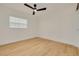 Bright bedroom features wood flooring, white walls, and a modern ceiling fan with a light at 1723 Cypress Ave, Belleair, FL 33756