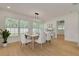 Bright dining area with natural light, modern furnishings and hardwood floors at 1723 Cypress Ave, Belleair, FL 33756