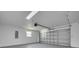Spacious garage with white walls, an automatic door, and an electric box at 1723 Cypress Ave, Belleair, FL 33756