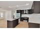 Open-concept kitchen boasts stainless appliances, modern island, and bright finishes at 1723 Cypress Ave, Belleair, FL 33756