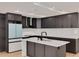 Modern kitchen with stainless appliances, gray cabinets, island, and white backsplash at 1723 Cypress Ave, Belleair, FL 33756