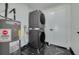Laundry area featuring full size washer and dryer, water heater, and striking floors at 1723 Cypress Ave, Belleair, FL 33756