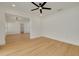 Bright living room with an open-concept, hardwood floors and new fixtures at 1723 Cypress Ave, Belleair, FL 33756