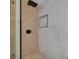 Modern tiled shower featuring a wood-look herringbone pattern and black fixtures at 1723 Cypress Ave, Belleair, FL 33756