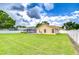 Sprawling backyard featuring lush green grass, a privacy fence, and ample space for outdoor activities and entertainment at 17302 Stetson Ln, Odessa, FL 33556
