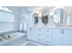 Stylish bathroom with a soaking tub, dual vanities, and elegant mirrors at 17302 Stetson Ln, Odessa, FL 33556