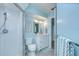 Light blue bathroom showcasing a glass-enclosed shower, vanity, and coordinated accessories at 17302 Stetson Ln, Odessa, FL 33556