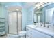 Bright bathroom featuring a glass-enclosed shower and a white vanity with lots of storage at 17302 Stetson Ln, Odessa, FL 33556