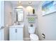 Updated half bath featuring a modern vanity, mirror, and decorative accents at 17302 Stetson Ln, Odessa, FL 33556