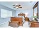Bedroom with a wood bed, dresser, ceiling fan, and a window that provides natural light at 17302 Stetson Ln, Odessa, FL 33556