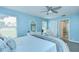 Bright bedroom with blue walls, luxury vinyl floors, and a comfortable accent chair at 17302 Stetson Ln, Odessa, FL 33556