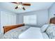 Bedroom with a wood-framed bed, closet, and window, creating a calming and functional space at 17302 Stetson Ln, Odessa, FL 33556