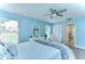 Calming bedroom with blue walls, luxury vinyl floors, and view to the ensuite bathroom at 17302 Stetson Ln, Odessa, FL 33556