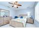 Cozy bedroom with a wooden sleigh bed, soft carpet, light blue walls, and a bright window at 17302 Stetson Ln, Odessa, FL 33556