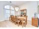 Bright dining room featuring chandelier, large windows, and wood-style floors at 17302 Stetson Ln, Odessa, FL 33556