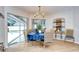 Inviting dining area with wicker chairs, blue tablecloth, and view of the pool area at 17302 Stetson Ln, Odessa, FL 33556