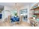 Dining area with stylish chandelier, table set for six, and sliding doors leading to a screened patio at 17302 Stetson Ln, Odessa, FL 33556