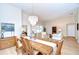 Spacious open concept dining room area with table, chandelier and hardwood floors at 17302 Stetson Ln, Odessa, FL 33556