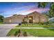 Charming single-Gathering home with a manicured lawn, three-car garage and lush landscaping at 17302 Stetson Ln, Odessa, FL 33556