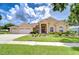 Charming single Gathering home with manicured lawn and three car garage at 17302 Stetson Ln, Odessa, FL 33556