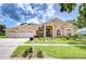 Charming single Gathering home with manicured lawn and three car garage at 17302 Stetson Ln, Odessa, FL 33556