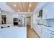 Bright kitchen with white cabinets, stainless steel appliances, and a decorative wood-paneled ceiling at 17302 Stetson Ln, Odessa, FL 33556